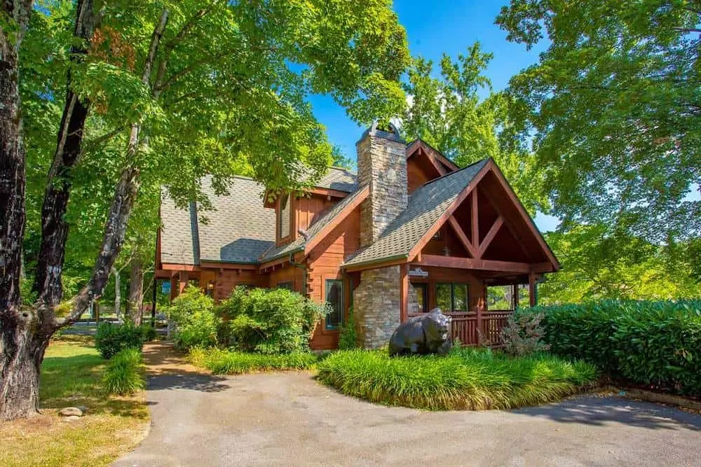 Pigeon Forge cabin named river's edge on a bright summer day surrounded by trees