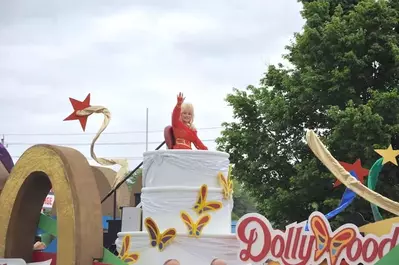 Dolly Parton waving to the crowd during her annual Homecoming Parade.