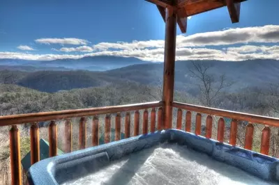 Hot tub on the deck of Changes in Latitude, one of our cabins with mountain views in Pigeon Forge.