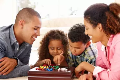 family playing board game in vacation cabin rentals in Pigeon Forge TN