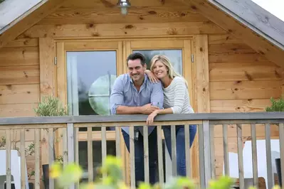 Couple enjoying time on their cabin deck while in a Pigeon Forge cabin vacation