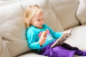 little girl reading on rainy day in vacation cabin rentals in Pigeon Forge TN