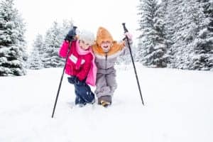 Two kids enjoying a winter hike.