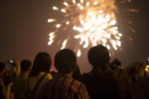 A group of people watching a fireworks show.