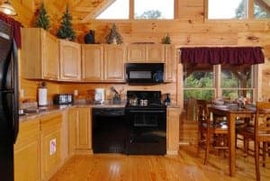 The charming kitchen of the Mountain Lake Getaway cabin in Pigeon Forge.