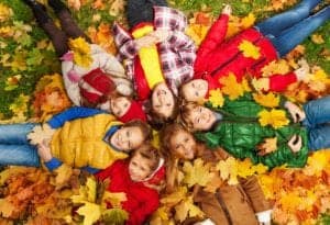 Kids laying in the leaves