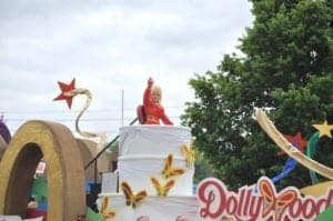 Dolly Parton waving to the crowd during her annual Homecoming Parade.
