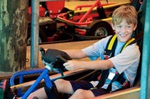 Young boy smiling on go kart