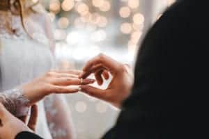 Couple exchanging rings at their wedding