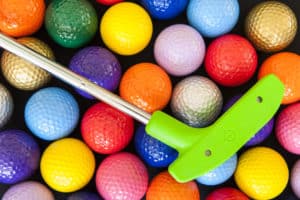 colorful golf balls and club